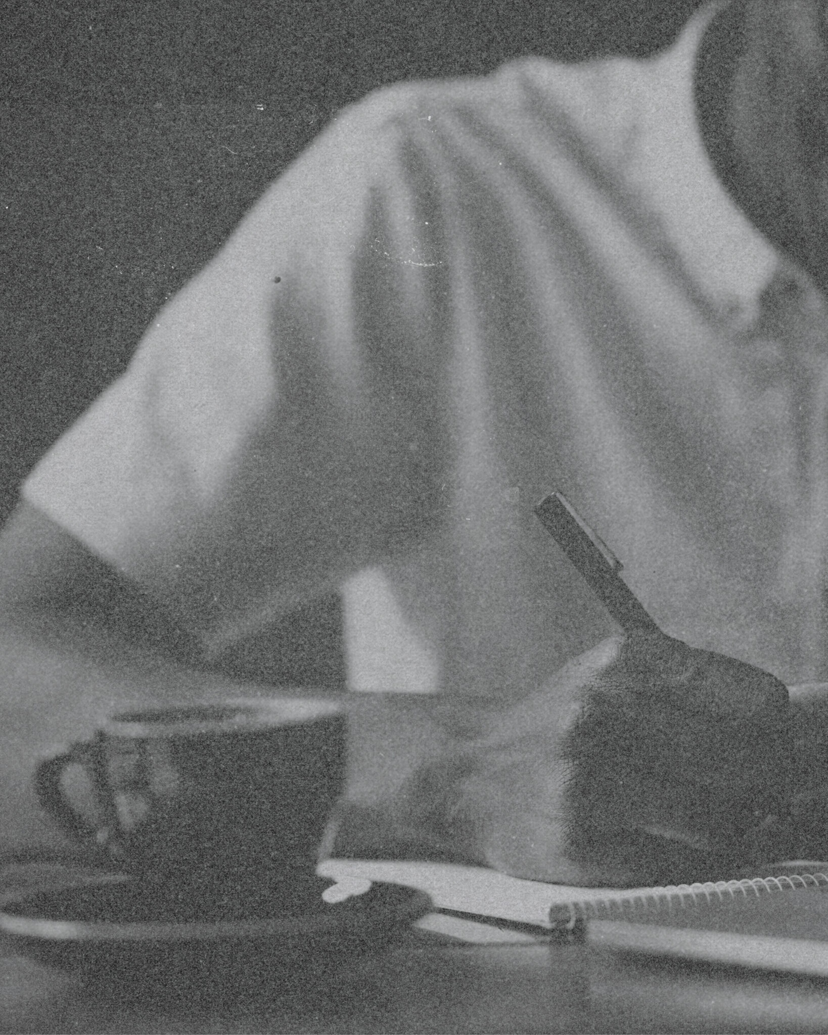 Photo of an individual seated at a desk, writing