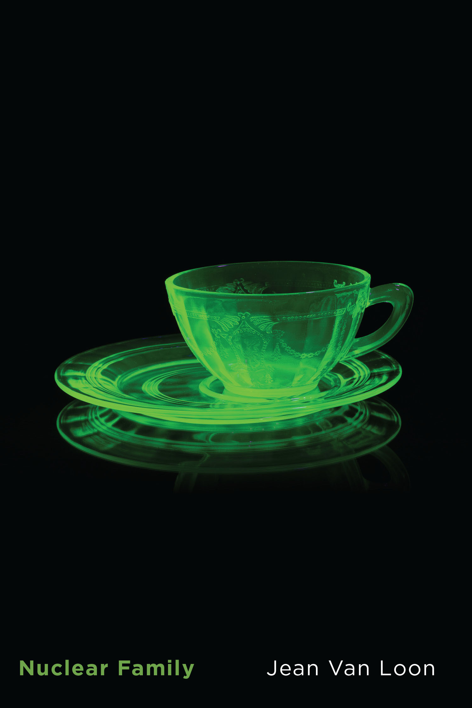 A green uranium-glass cup tilting off-centre on its saucer radiates against an ominous black background.